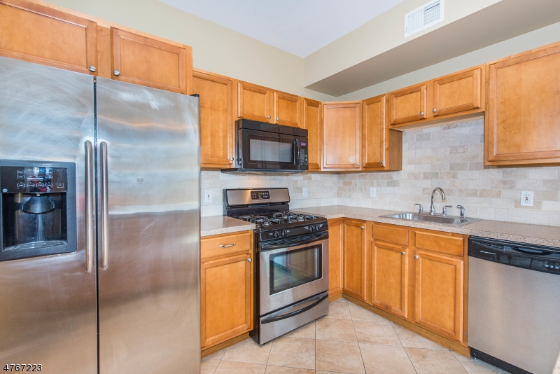 1677 Springfield Avenue, Unit 14 Maplewood, NJ 07040 - Photo 8 of 13 a kitchen with stainless steel appliances granite countertop a refrigerator a sink a stove top oven and a dishwasher