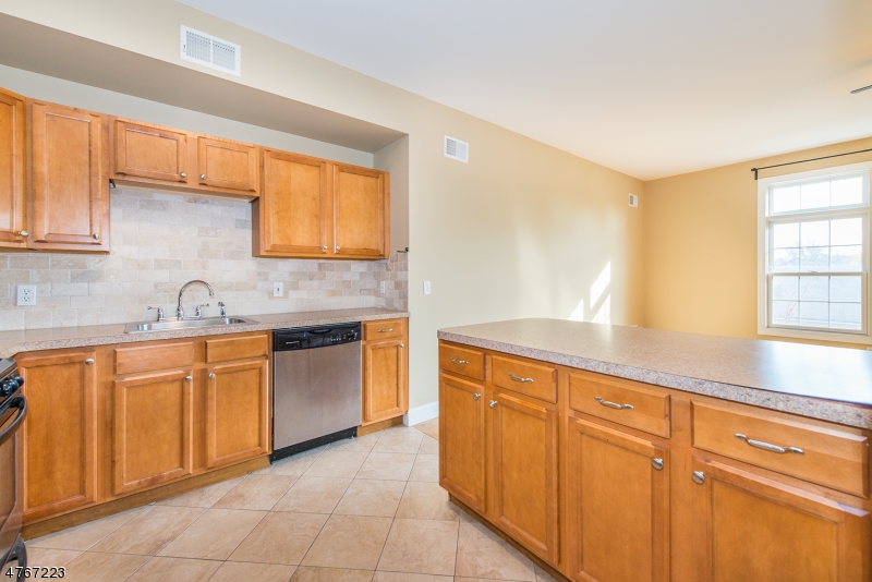 1677 Springfield Avenue, Unit 14 Maplewood, NJ 07040 - Photo 9 of 13 a kitchen with stainless steel appliances granite countertop a sink and cabinets