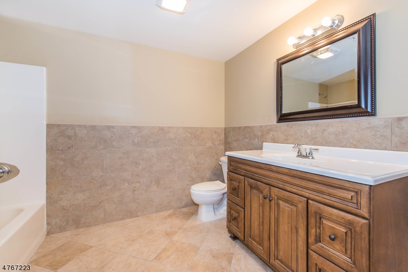 1677 Springfield Avenue, Unit 14 Maplewood, NJ 07040 - Photo 10 of 13 a bathroom with a sink a toilet and mirror