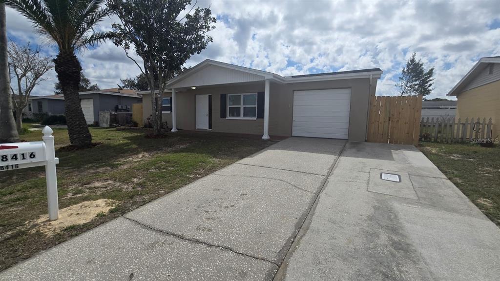 8416 Redfield Drive Port Richey, FL 34668 - Photo 1 of 1 front view of a house with a yard