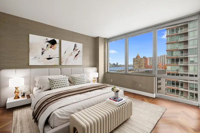 a bedroom with a bed and a large window