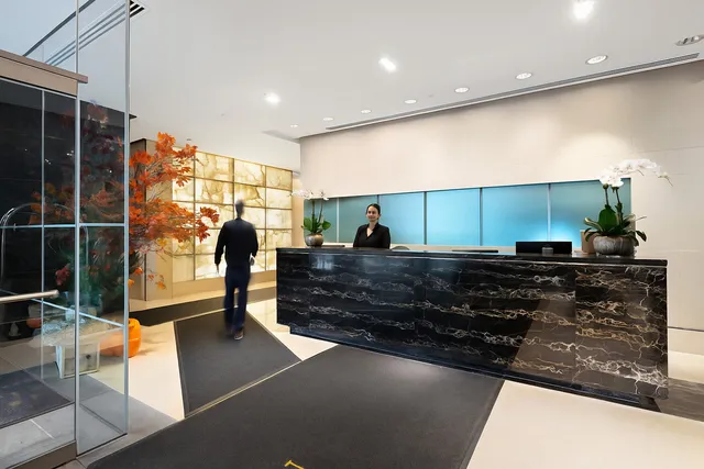 a living room with stainless steel appliances granite countertop a barbecue grill and cabinets