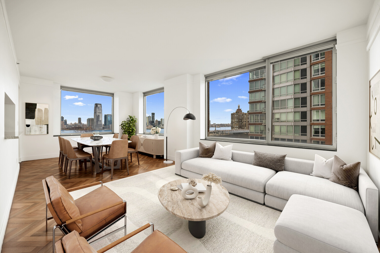 10 West Street, Unit 15C Manhattan, NY 10004 - Photo 2 of 23 a living room with furniture and a large window