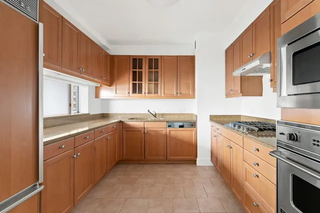 a kitchen with stainless steel appliances granite countertop a stove and a sink