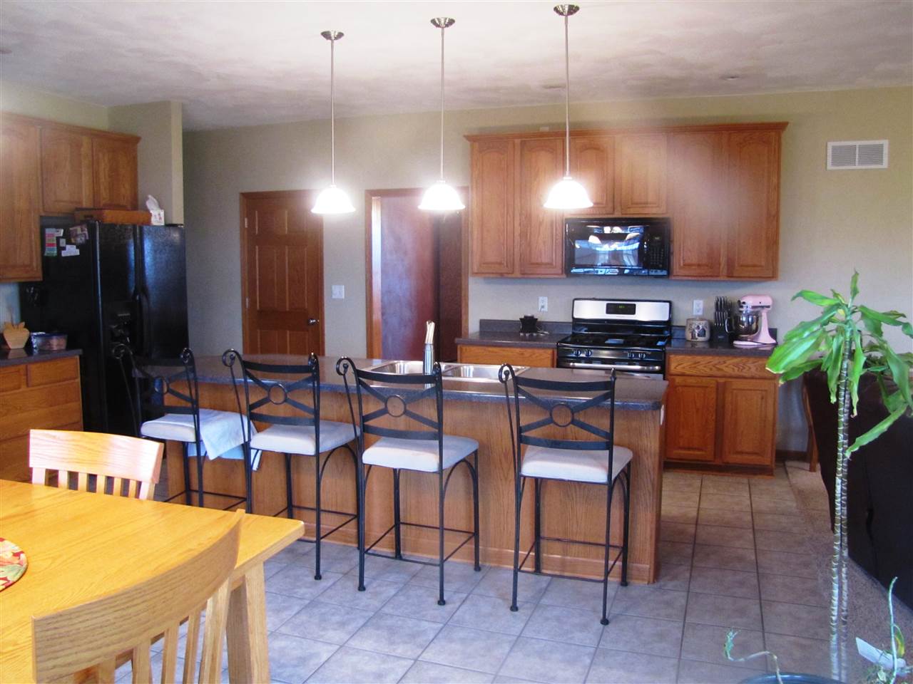 19085 East Crill Road Monroe Center, IL 61052 - Photo 6 of 23 a room with stainless steel appliances kitchen island granite countertop furniture and a dining table