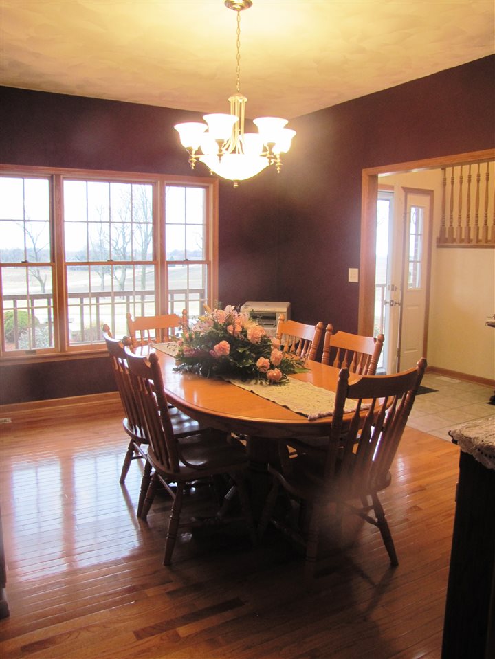 19085 East Crill Road Monroe Center, IL 61052 - Photo 10 of 23 a view of a dining room with furniture a chandelier and wooden floor