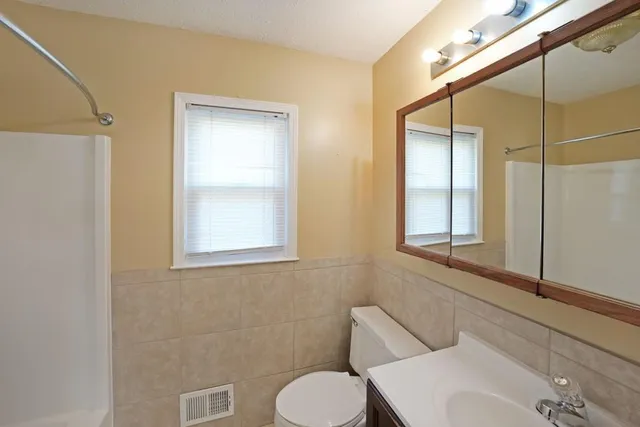 a bathroom with a toilet sink and shower