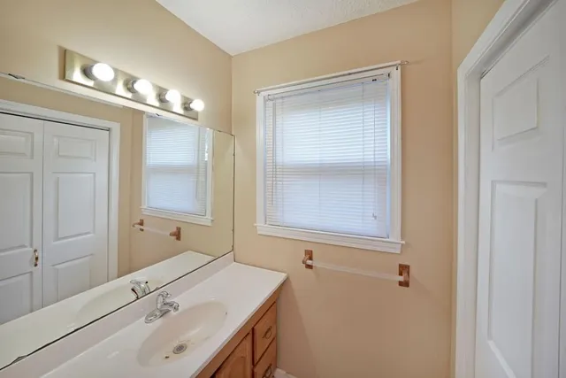 a bathroom with a sink a vanity and a mirror
