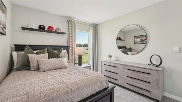 a bedroom with a bed and a dresser