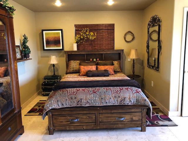 9290 Cramer Road Auburn, CA 95602 - Photo 41 of 67 a bedroom with a bed and paintings on the wall