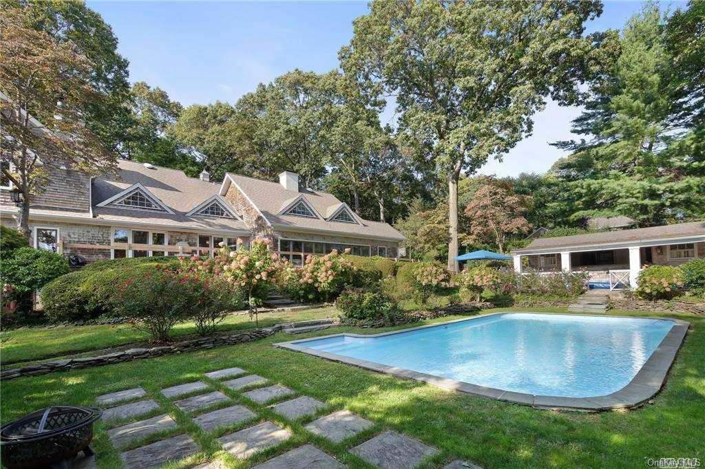 8 Spring Hollow Road Centerport, NY 11721 - Photo 1 of 1 a view of a house with backyard and sitting area