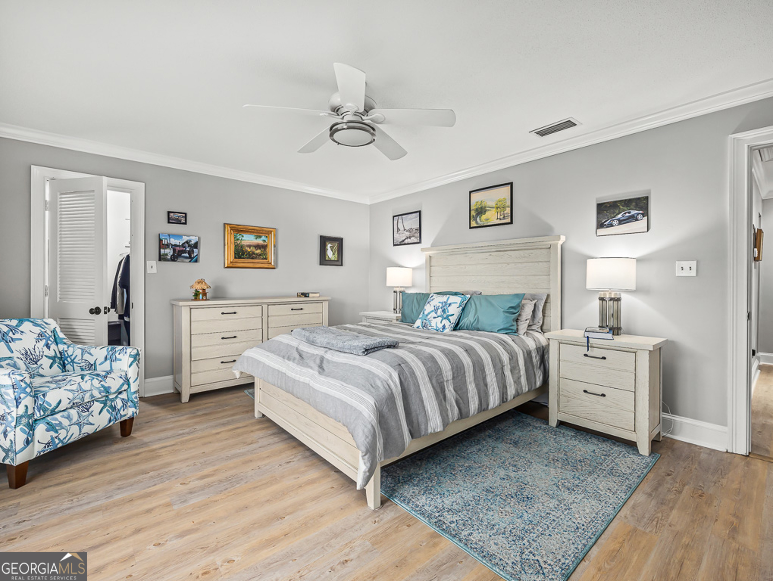 103 Cater Street St. Simons, GA 31522 - Photo 13 of 30 a spacious bedroom with a bed and a dresser