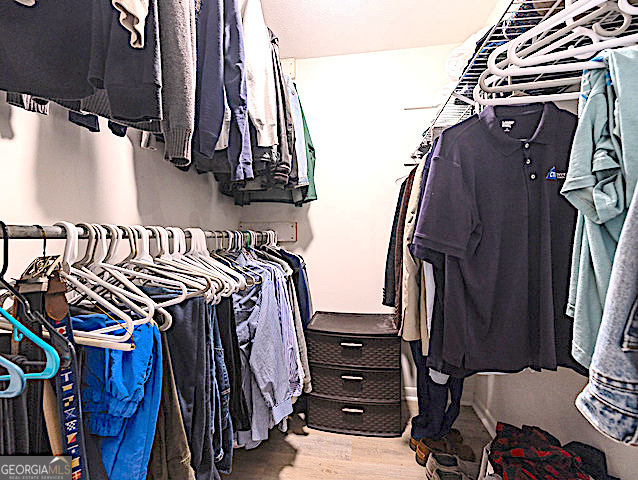 103 Cater Street St. Simons, GA 31522 - Photo 16 of 30 a view of walk in closet with clothes and shoes