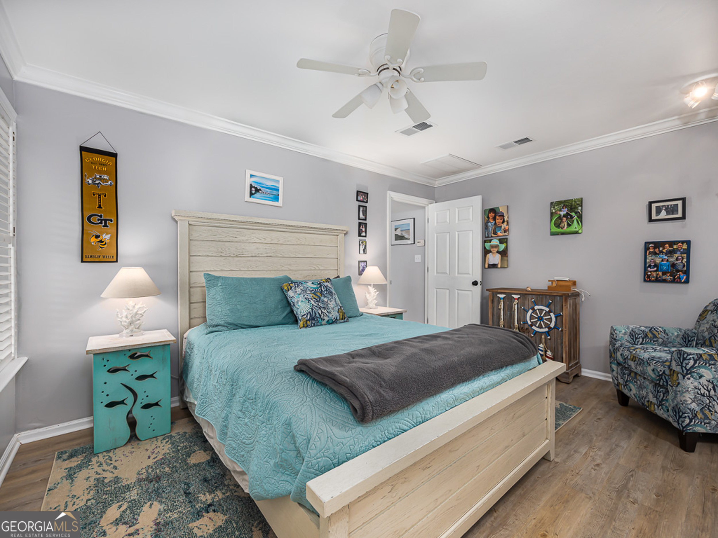 103 Cater Street St. Simons, GA 31522 - Photo 17 of 30 a bedroom with a bed and a chandelier