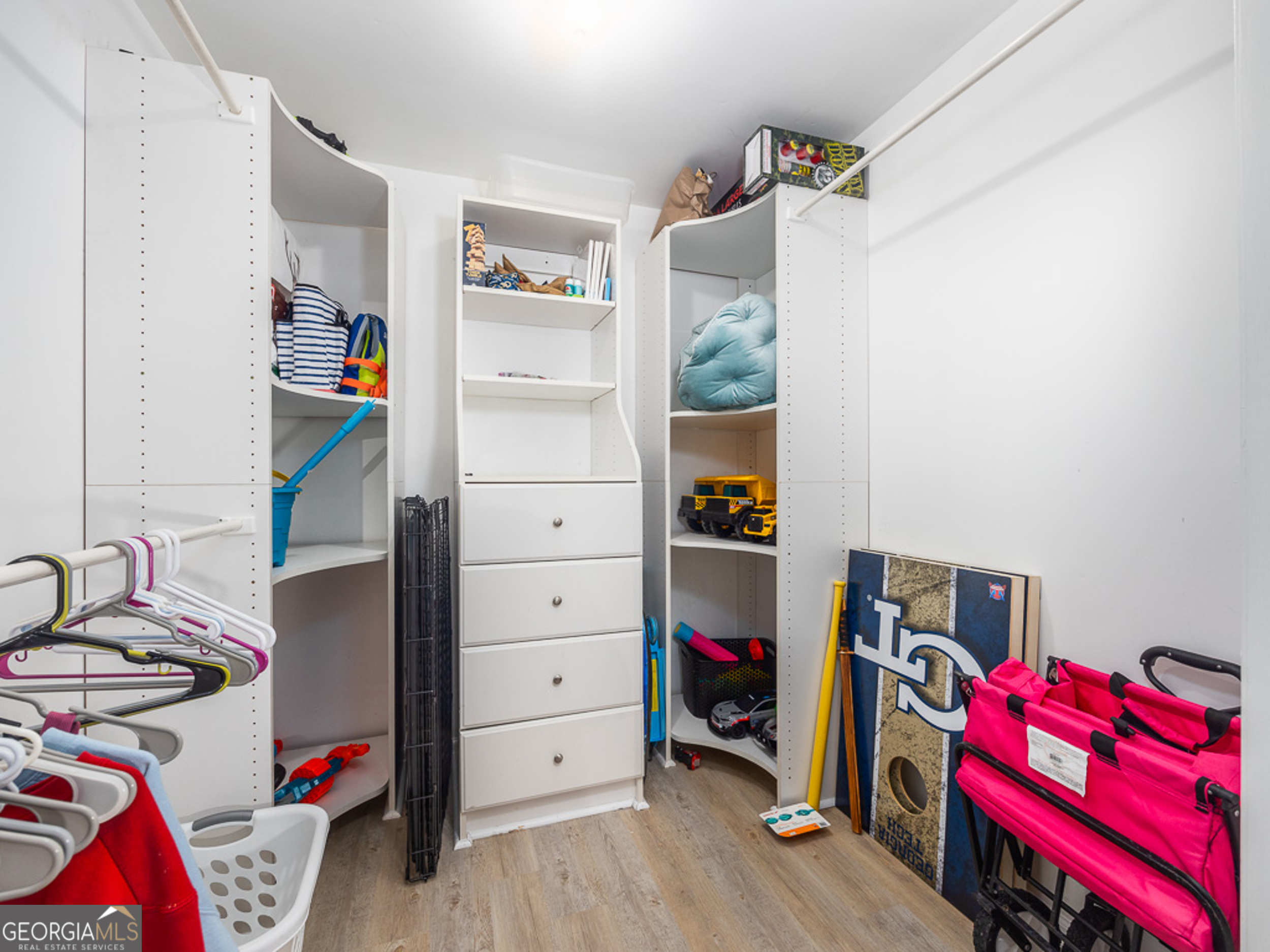 103 Cater Street St. Simons, GA 31522 - Photo 18 of 30 a view of walk in closet with clothes and shoes