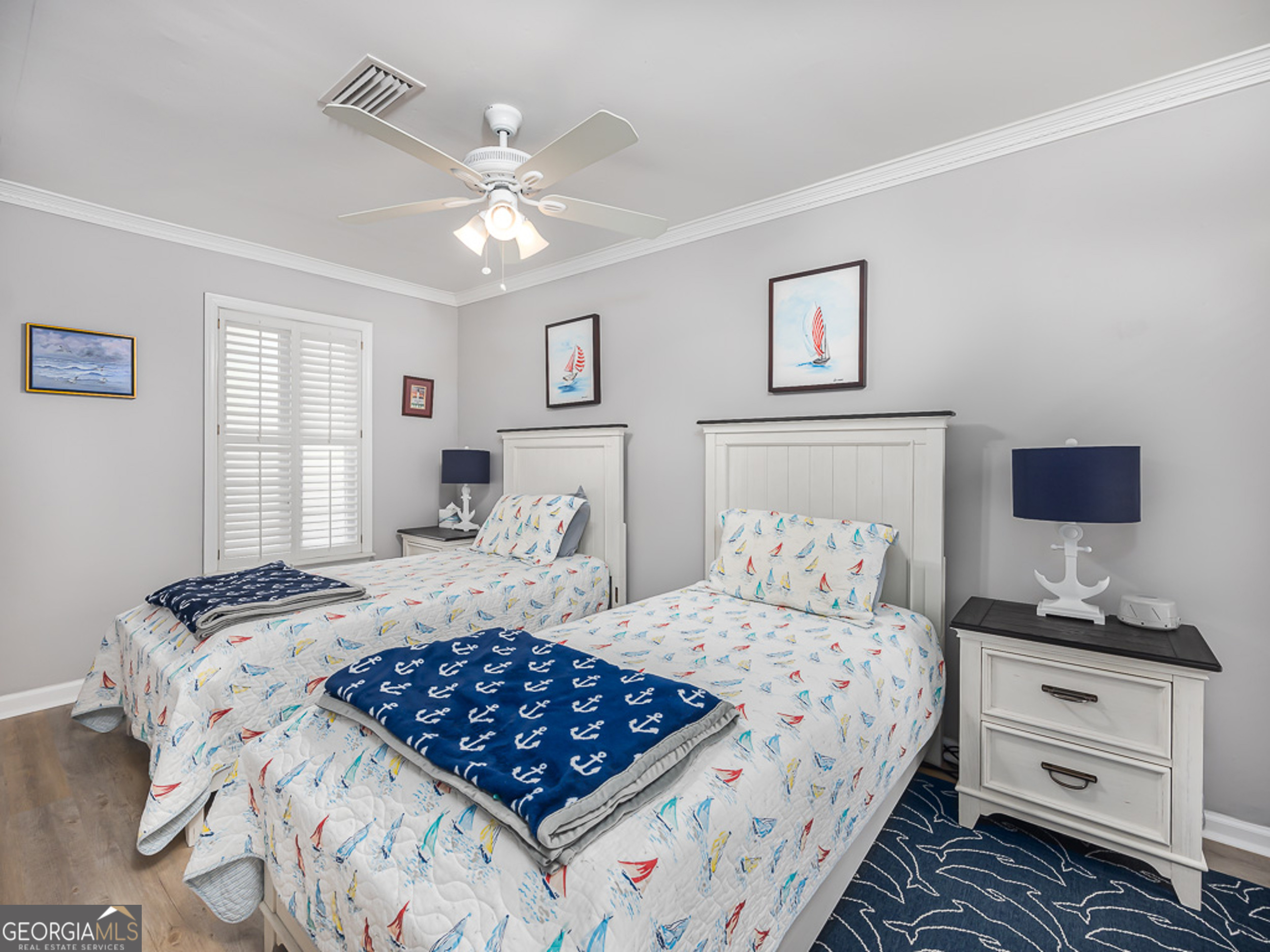 103 Cater Street St. Simons, GA 31522 - Photo 20 of 30 a bedroom with a large bed and a chandelier