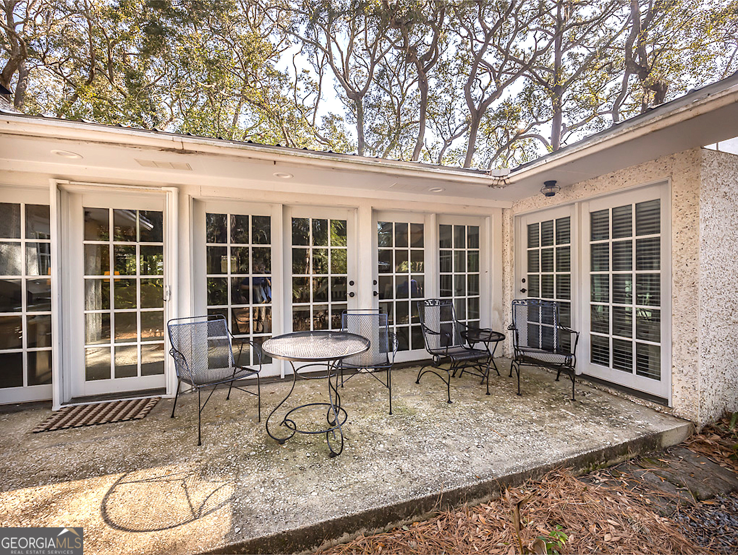 103 Cater Street St. Simons, GA 31522 - Photo 27 of 30 a outdoor space with a large window and sitting area