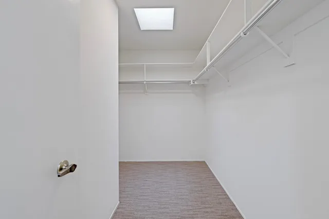a kitchen with granite countertop white cabinets and stainless steel appliances