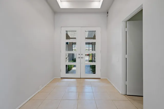 a view of empty room with floor to ceiling windows and floor to ceiling window