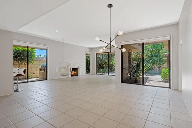a view of an empty room with a fireplace and a window