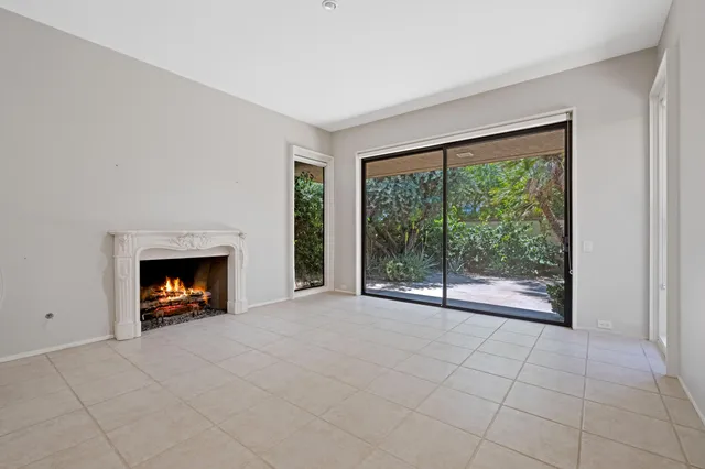 a view of a livingroom with a fireplace and window