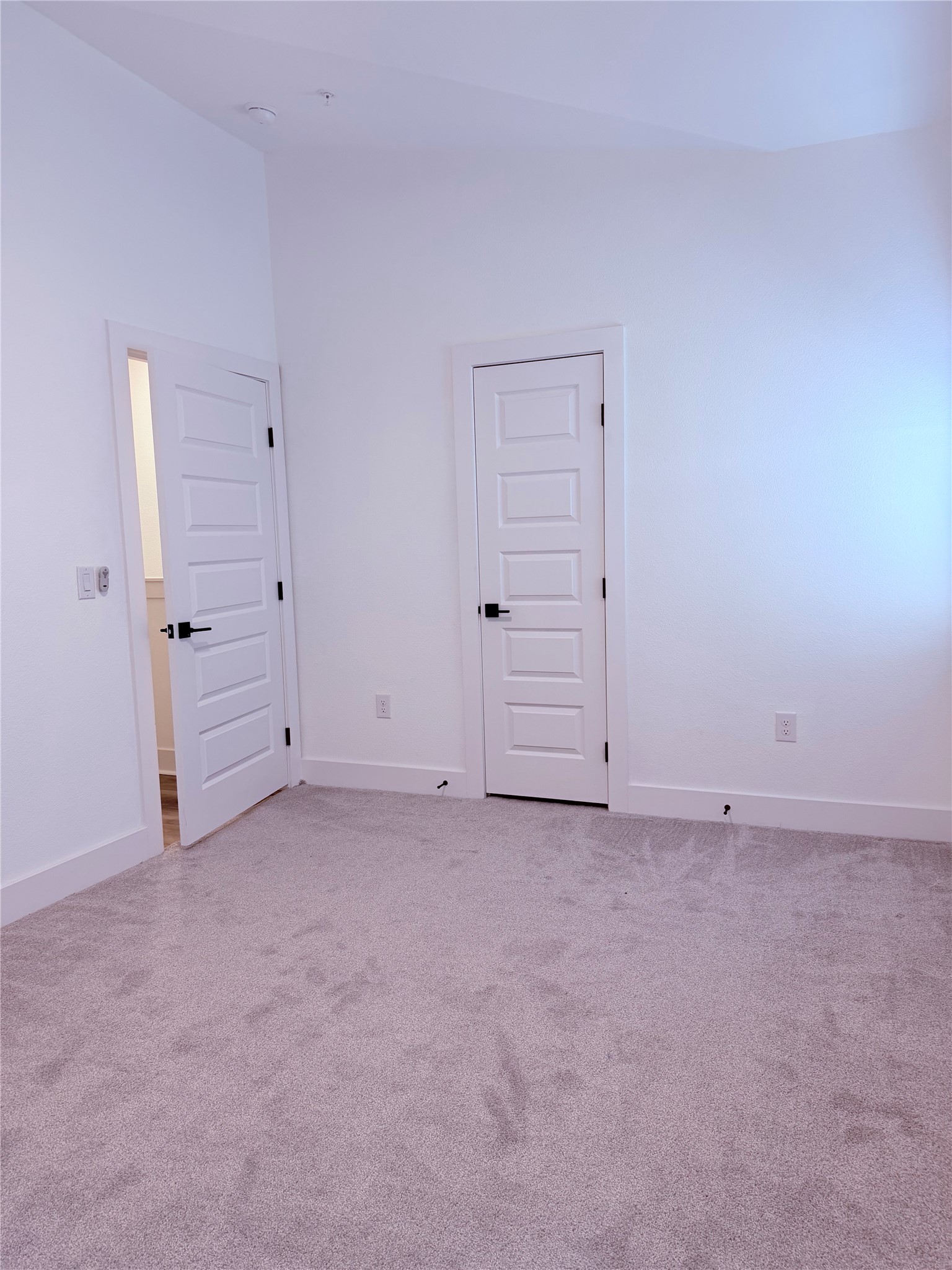 1417 Kramer Lane, Unit 7 Austin, TX 78758 - Photo 6 of 24 A well-lit room featuring soft carpeting and multiple panel doors, ready for personalized touches.