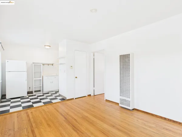 a view of a room with wooden floor