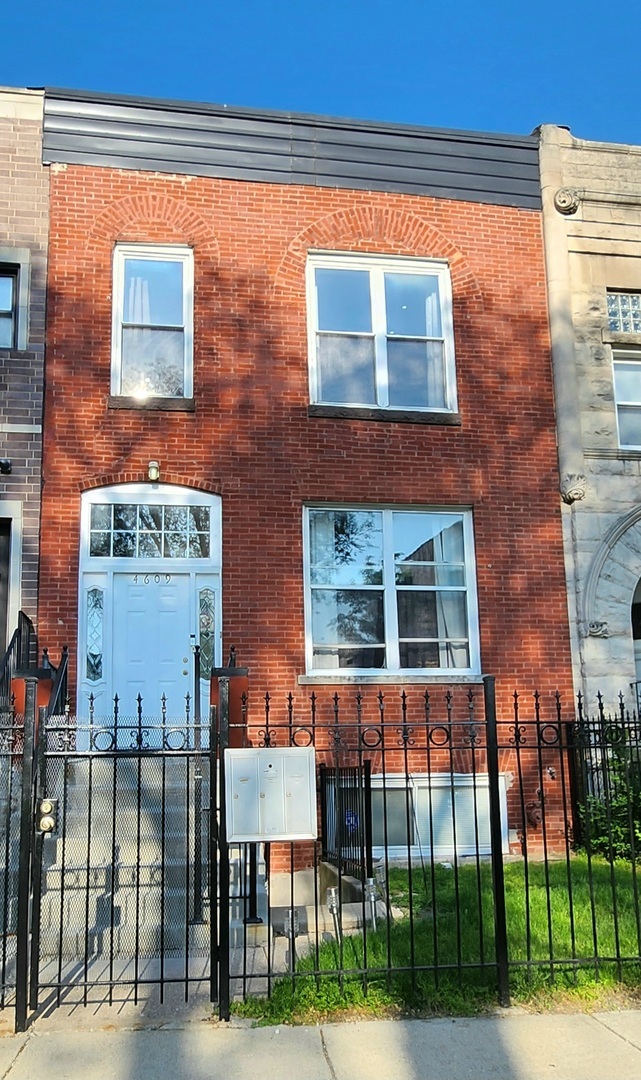 4609 South Vincennes Avenue, Unit 2 Chicago, IL 60653 - Photo 1 of 1 a front view of a house with a glass windows