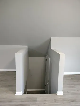 a view of an empty room with wooden floor