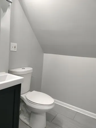 a white toilet sitting next to a white sink