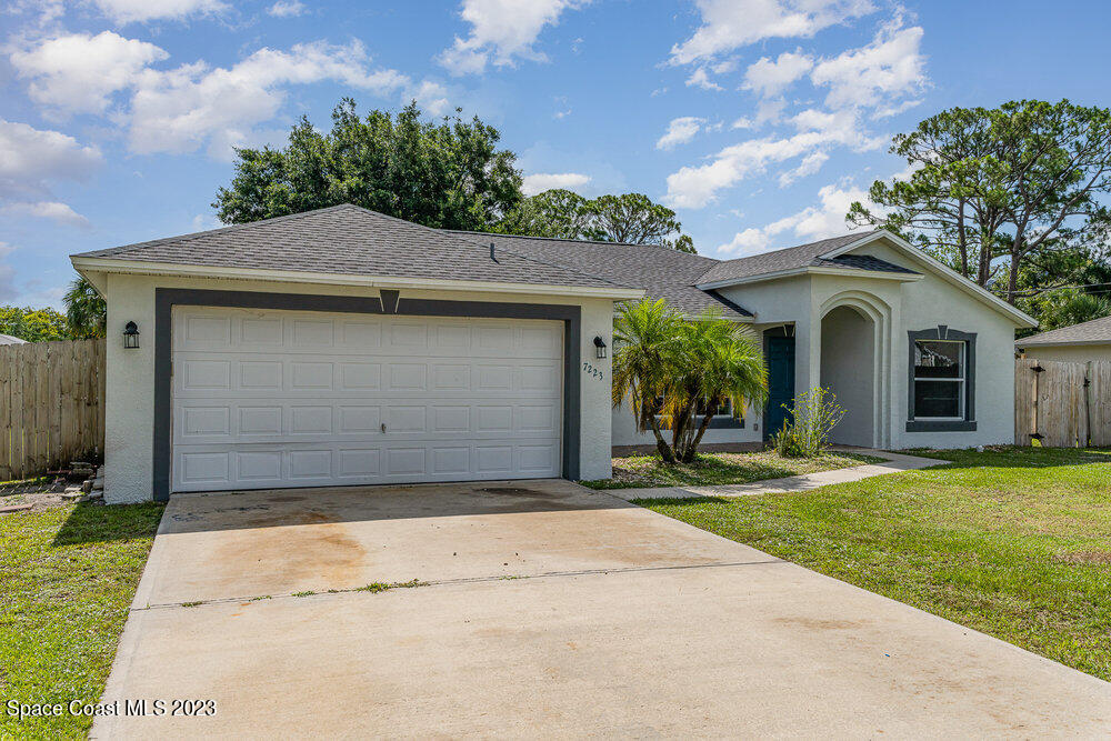 7223 Achilles Road Cocoa, FL 32927 - Photo 3 of 37 a front view of a house with a garden
