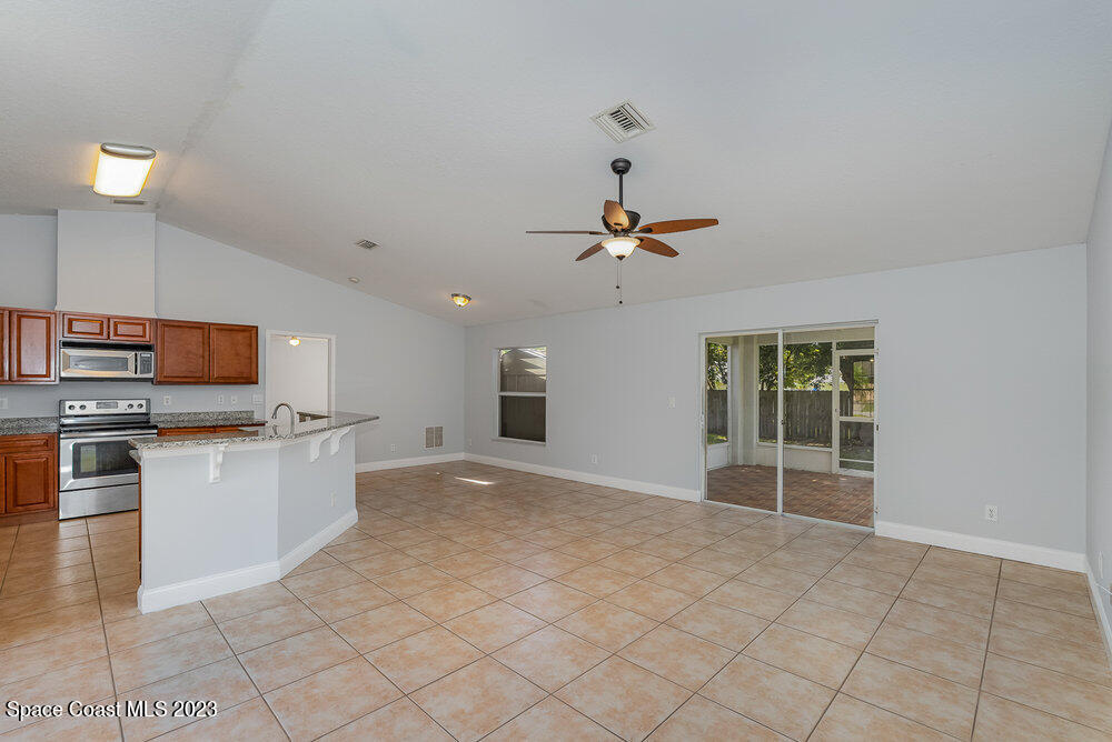 7223 Achilles Road Cocoa, FL 32927 - Photo 8 of 37 a view of a kitchen with microwave and cabinets
