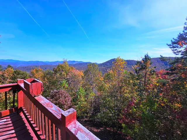 a picture of a kitchen with white cabinets and refrigerator