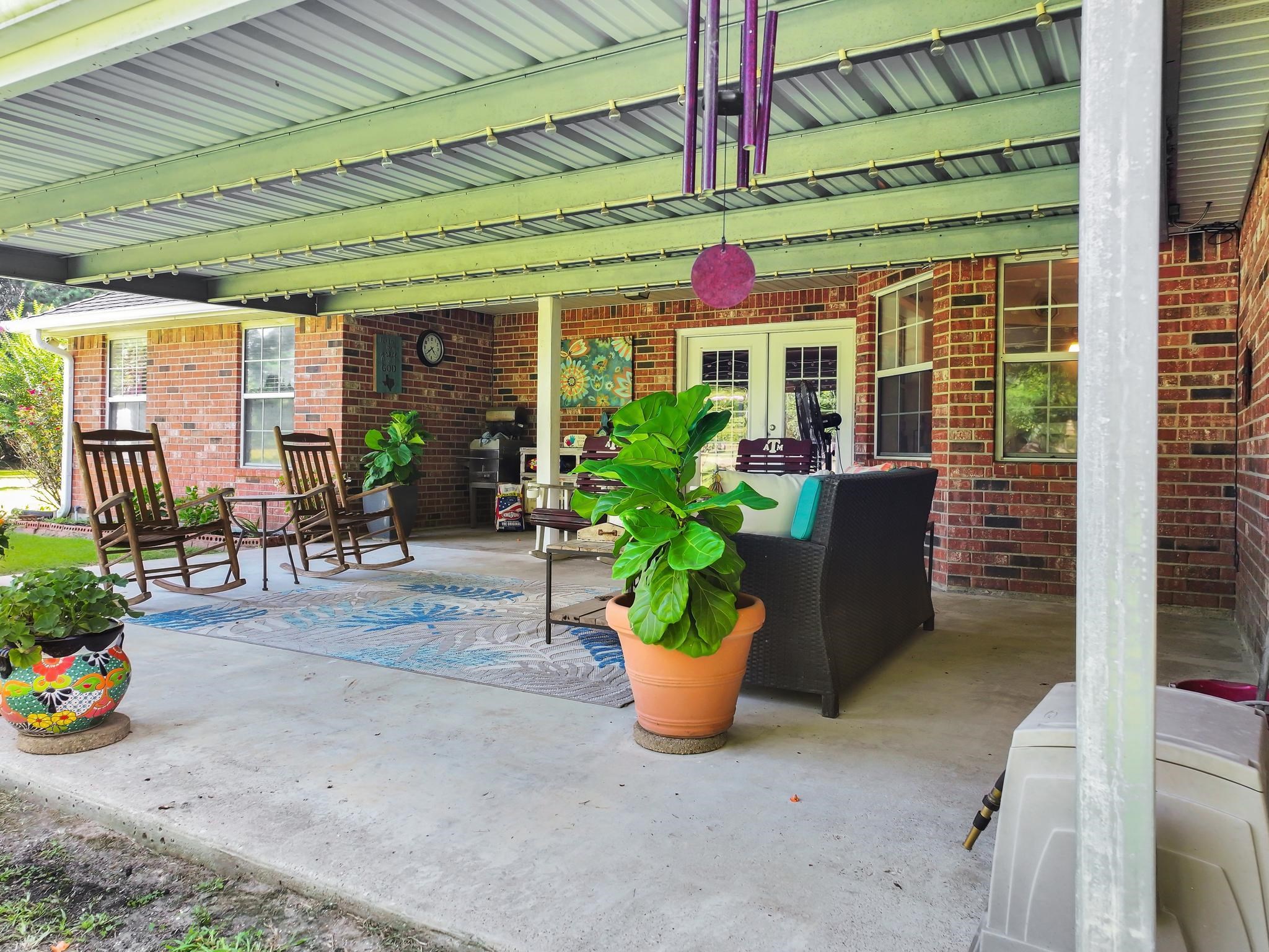 738 Parish Road Orange, TX 77632 - Photo 40 of 45 a view of a patio with table and chairs under an umbrella