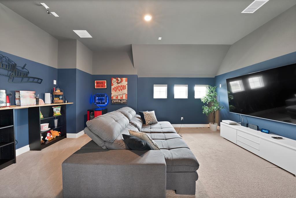 1010 Adair Road Prosper, TX 75078 - Photo 22 of 39 a living room with furniture and a flat screen tv