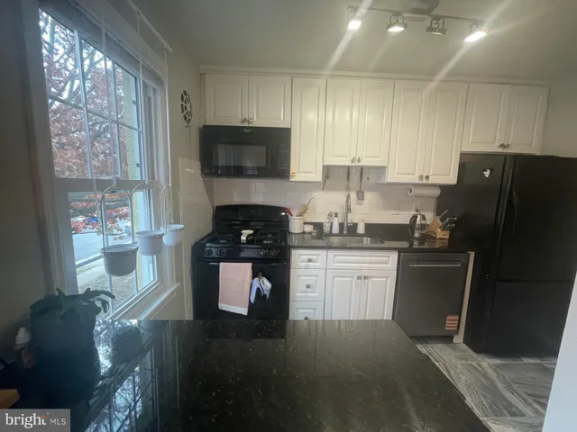 a kitchen with a sink appliances and cabinets