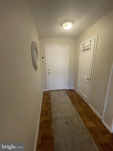 a living room with furniture a lamp and a potted plant