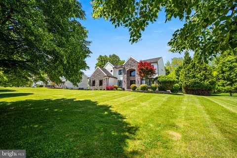 an aerial view of a house with garden space and street view
