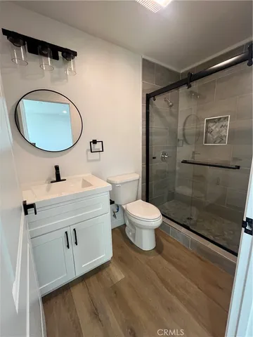 a bathroom with a sink mirror vanity and toilet