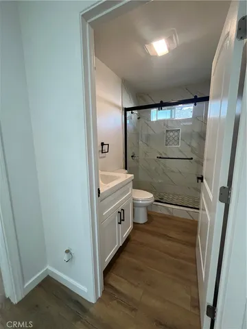 a bathroom with a double vanity sink toilet and shower