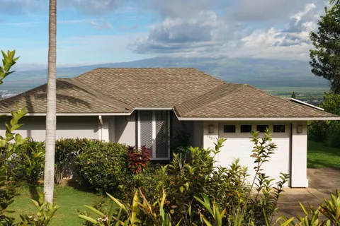 a view of a house with a yard and sitting area