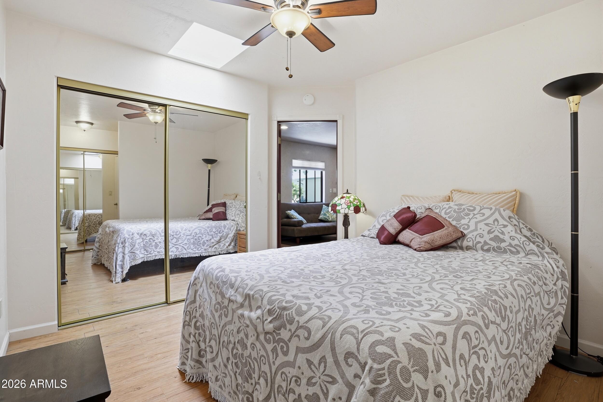 6334 East Albany Street Mesa, AZ 85205 - Photo 53 of 72 a bedroom with a large bed and a chandelier fan