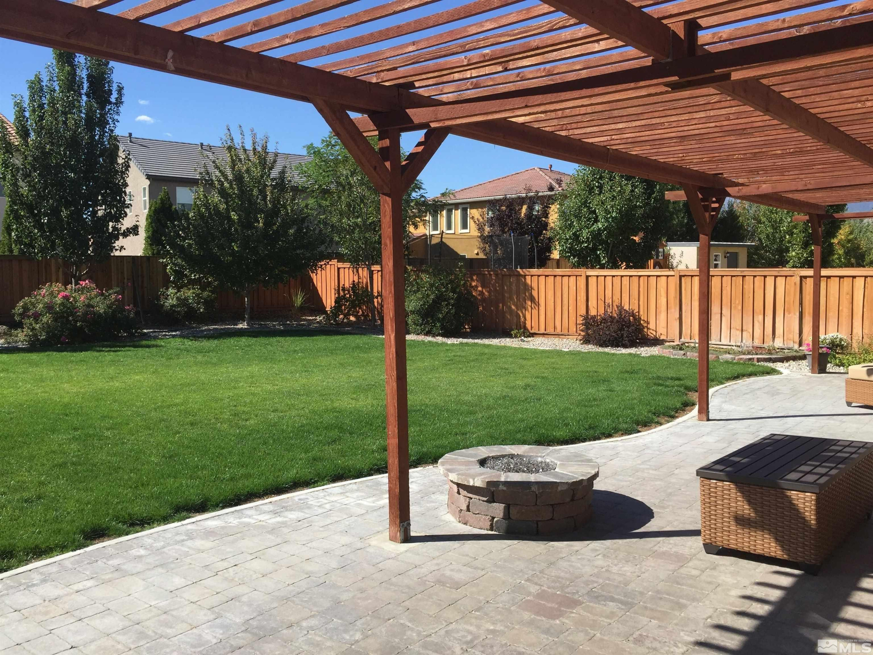 470 Manciano Way Reno, NV 89521 - Photo 21 of 22 a view of a backyard with table and chairs under an umbrella