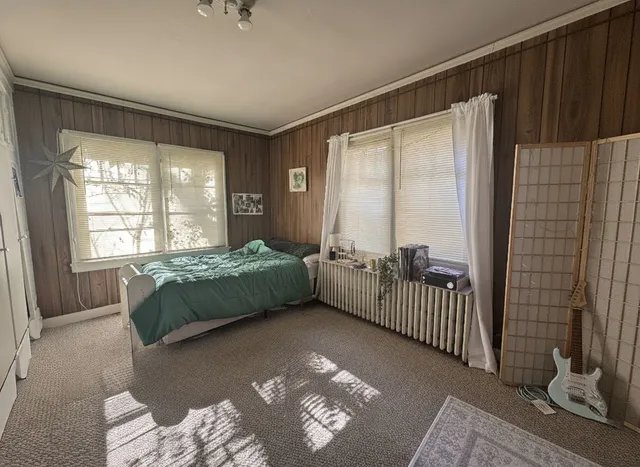 a bedroom with a bed and a window