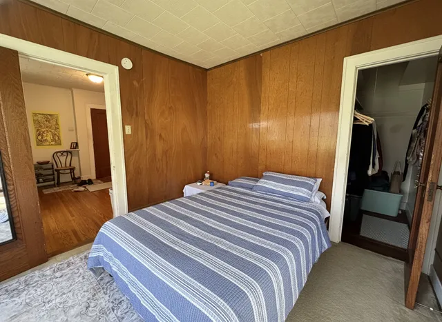a bedroom with a bed and a walk in closet