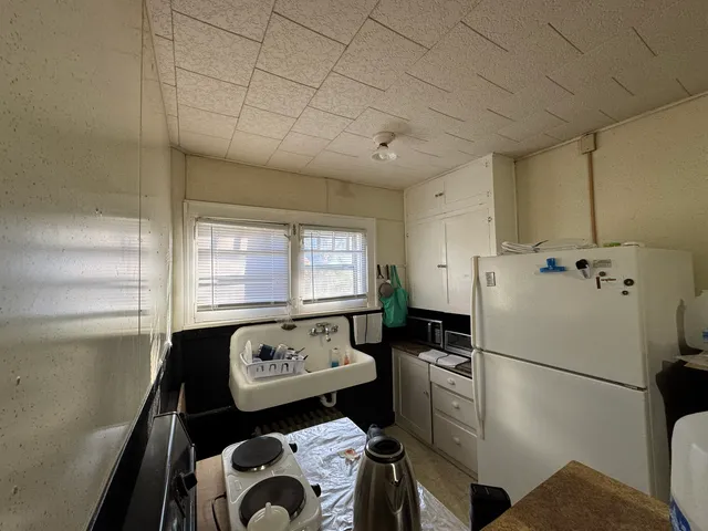 a kitchen with a refrigerator and a stove