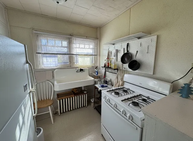 a kitchen with a stove and a refrigerator