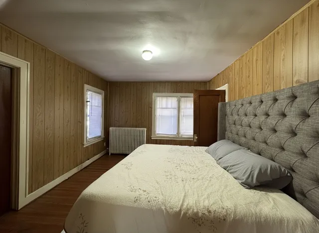 a bedroom with a bed couch and window