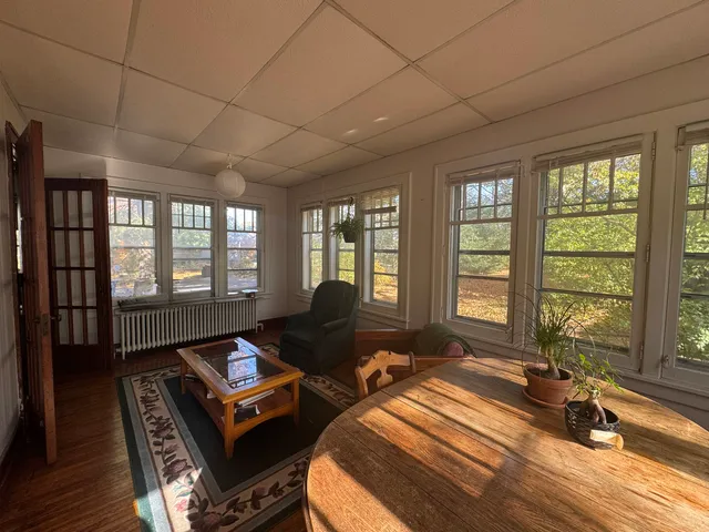 a living room with furniture and a floor to ceiling window