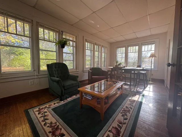 a living room with furniture and a floor to ceiling window